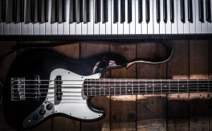 piano and guitar on wooden background closeup ,concept musical instruments